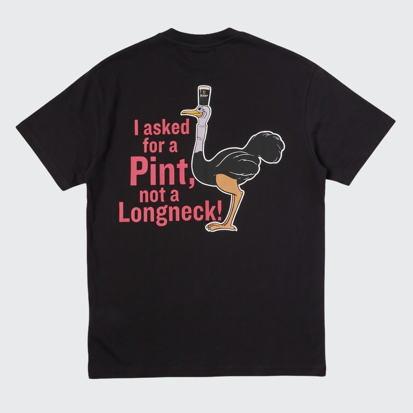 Introducing the Guinness Gilroy Ostrich Tee – Black from Guinness Webstore US. This limited edition tee features a playful ostrich illustration carrying a pint of beer on its head, highlighted by bold pink lettering that says, “I asked for a Pint, not a Longneck!” A must-have for fans of classic pub humor and distinctive style, this t-shirt is part of the iconic Gilroy collection.