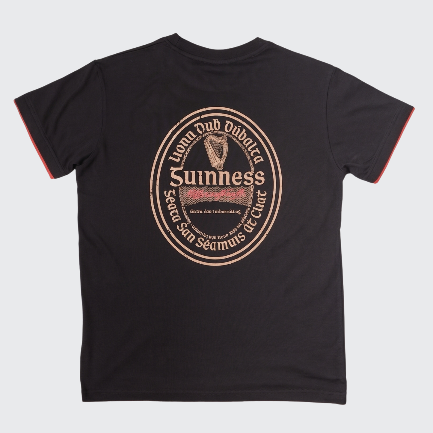 The Guinness Irish Label Black Tee from the Guinness Webstore US showcases a bold vintage-inspired Guinness label and harp graphic on the back, complete with English and Irish text and eye-catching red sleeve trim. It’s the ideal black tee for fans looking to celebrate classic Irish beer style.