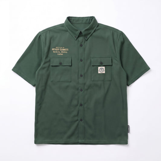 The Guinness Cooperage Work Shirt is a forest green, short-sleeve, heavyweight cotton button-up with two chest pockets, embroidered text left, and logo patch right.