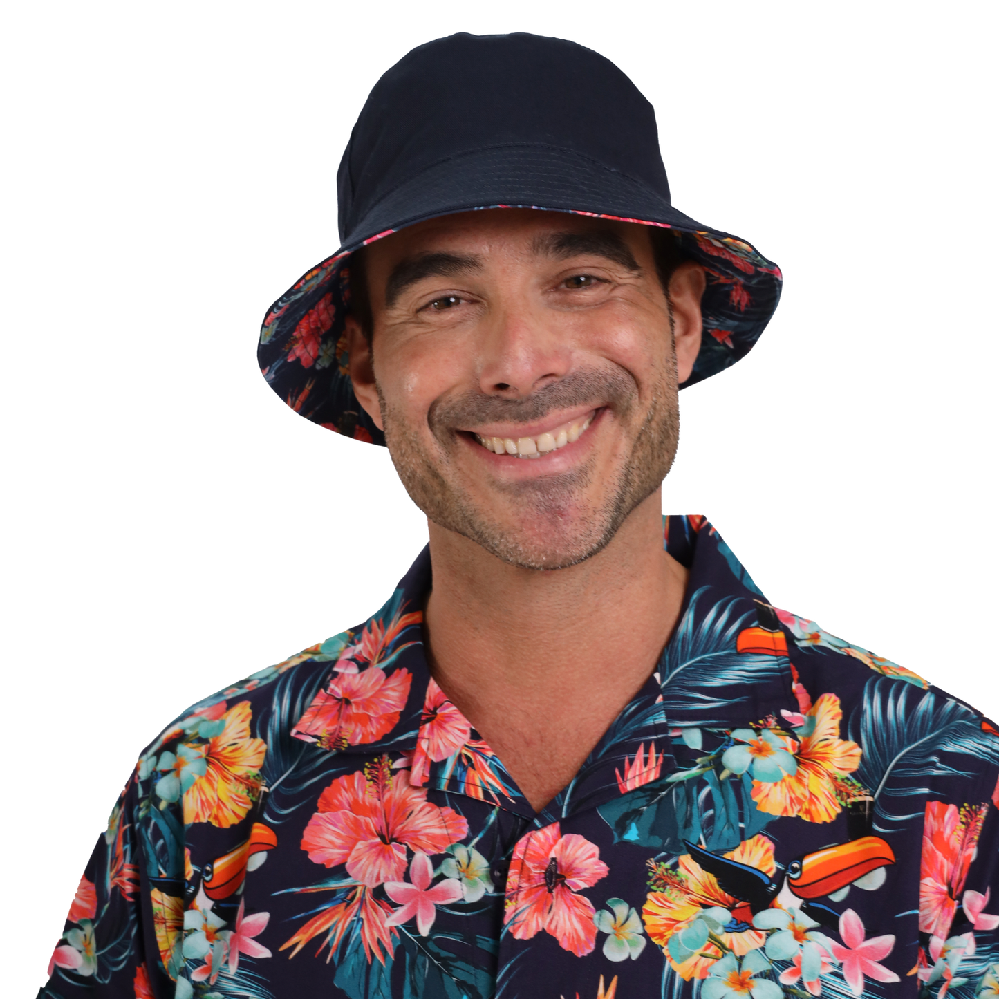 A smiling man wearing a floral shirt and a dark Guinness Hawaiian Reversible Bucket Hat from Guinness Webstore US against a white background.