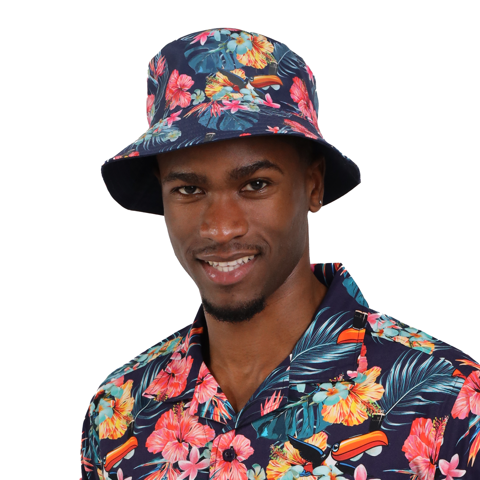 A man wearing a dark floral Guinness Hawaiian Reversible Bucket Hat from the Guinness Webstore US and a matching floral shirt smiles at the camera.