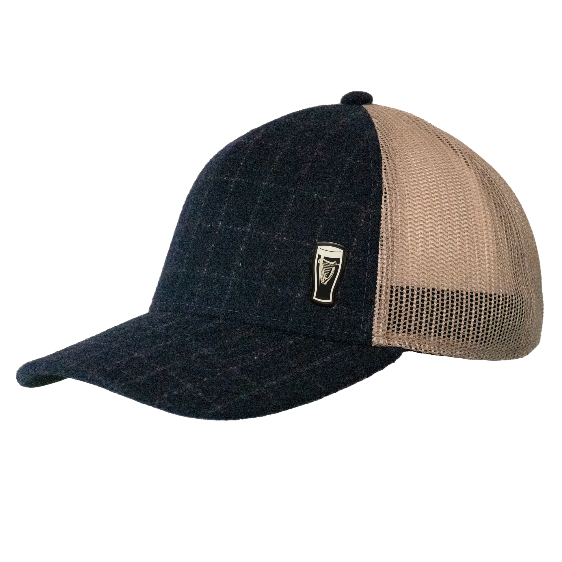 The Guinness Checked Trucker Cap from Guinness Webstore US features black and beige panels, a mesh back, and a small metal pint glass emblem on the front left panel—an understated tribute to Irish heritage.