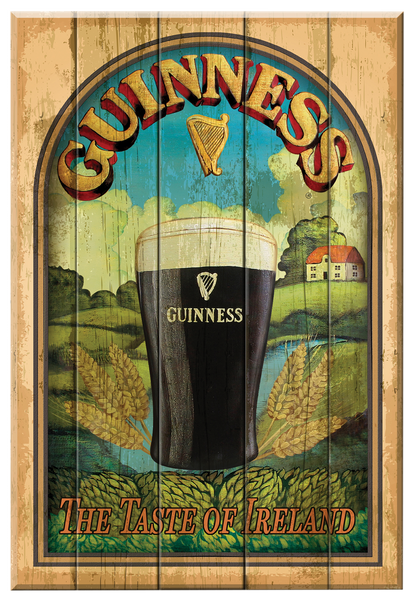 A vintage-style wooden sign features a pint of Guinness set against the backdrop of the Irish countryside, complete with wheat and a rural scene. The text "Guinness: The Taste of Ireland" is elegantly displayed, accompanied by a harp symbol and a charming cottage. This makes it perfect for those seeking an authentic Guinness wall plaque. Available from the Guinness Webstore US under the name "Guinness Wooden Nostalgic Sign - Taste Of Ireland.