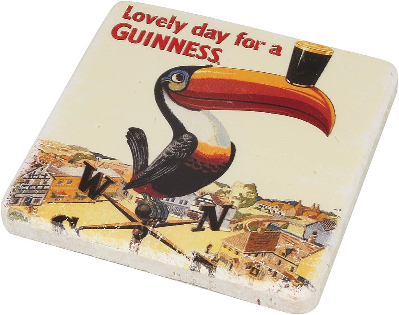 The Guinness Gilroy Toucan Stone Coaster features the iconic toucan balancing a pint above "Lovely day for a GUINNESS" and a charming town illustration. By Guinness.