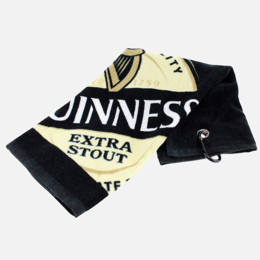 The Guinness Label Golf Towel is a black and beige towel featuring the Extra Stout logo, complete with a metal grommet and hook for easy hanging—a stylish choice for any Guinness fan.