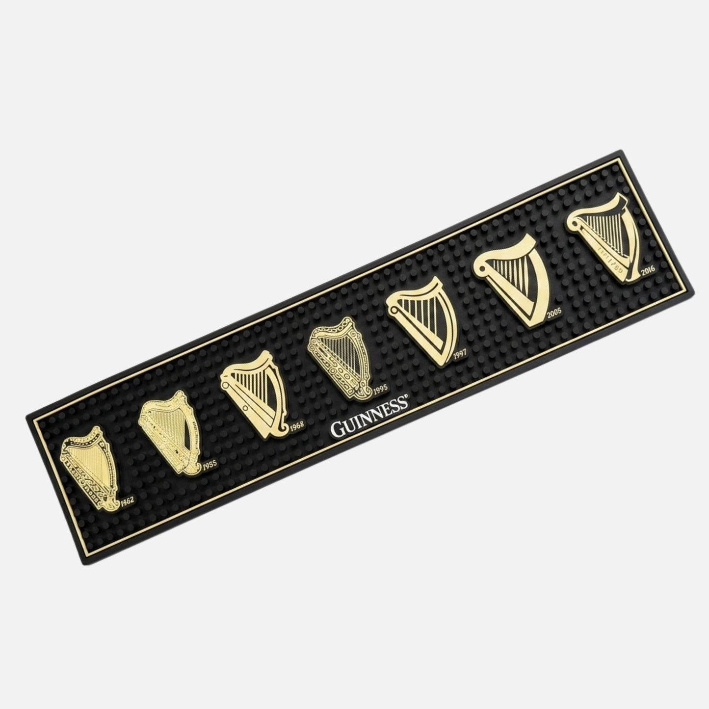 The Guinness Evolution of the Harp PVC Bar Mat features seven gold harp logos with years from 1862 to 2016 and a central Guinness logo—a stylish black bar accessory by Guinness for your home bar.