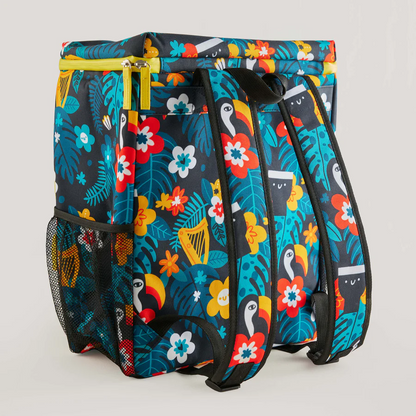 The Guinness x Fatti Burke Hawaiian Cooler Bag from Guinness Webstore UK features a colorful floral and toucan pattern, black straps, a mesh side pocket, and a yellow top zipper inspired by Fatti Burke Illustrations.