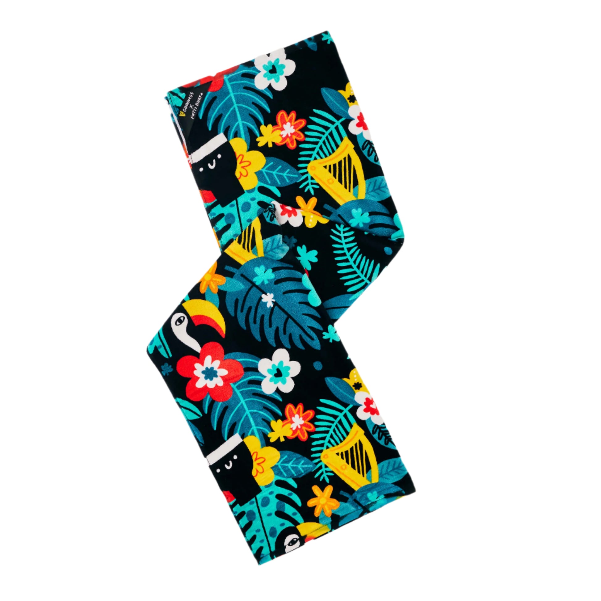 Bring a lively island vibe to your beach or poolside experience with the Guinness x Fatti Burke Beach Day Bundle from Guinness Webstore US—a rectangular fabric towel adorned with a colorful tropical pattern of leaves, flowers, toucans, and monkeys on a black background.