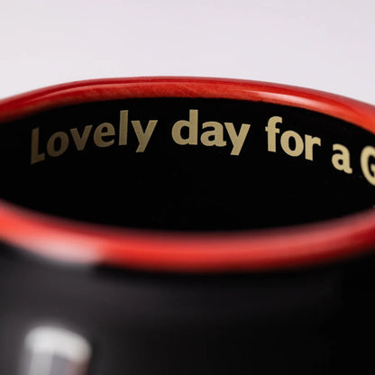 Close-up of the inside rim of a Guinness Toucan Black Mini Barrel Mug from Guinness Webstore US, with red trim and the printed phrase "Lovely day for a Gu..." on the inner surface.