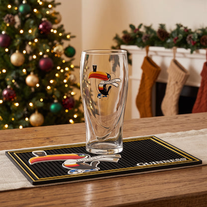 The Guinness Soccer Holiday Gift Set from Guinness Webstore US is the perfect soccer gift, featuring a toucan glass and bar mat amid festive Christmas decor.