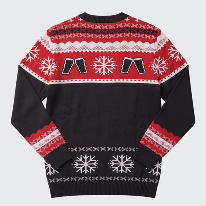 A festive Christmas sweater shown from the back, featuring a black body with red and white patterned bands, including snowflakes, geometric designs, and two clinking beer glasses.