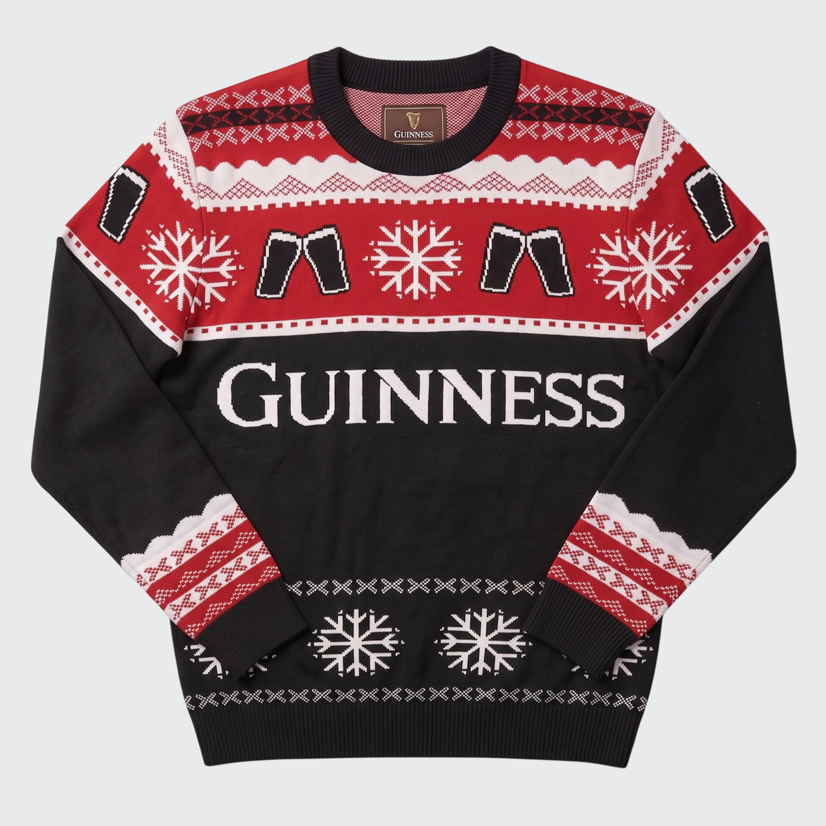 A black and red Guinness Christmas sweater with white patterns, featuring the brand name 'GUINNESS' across the chest and a small 'CLAIMED' label inside the collar, shown flat on a light gray background.