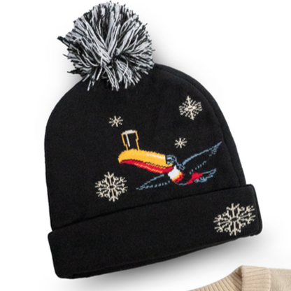 The black and beige sweaters adorned with a holiday toucan, snowflakes, and "Guinness" lettering are the perfect match for the Guinness Holiday Toucan Beanie from Guinness Webstore US, complete with a playful pom pom. It's a cozy addition to your winter wardrobe.