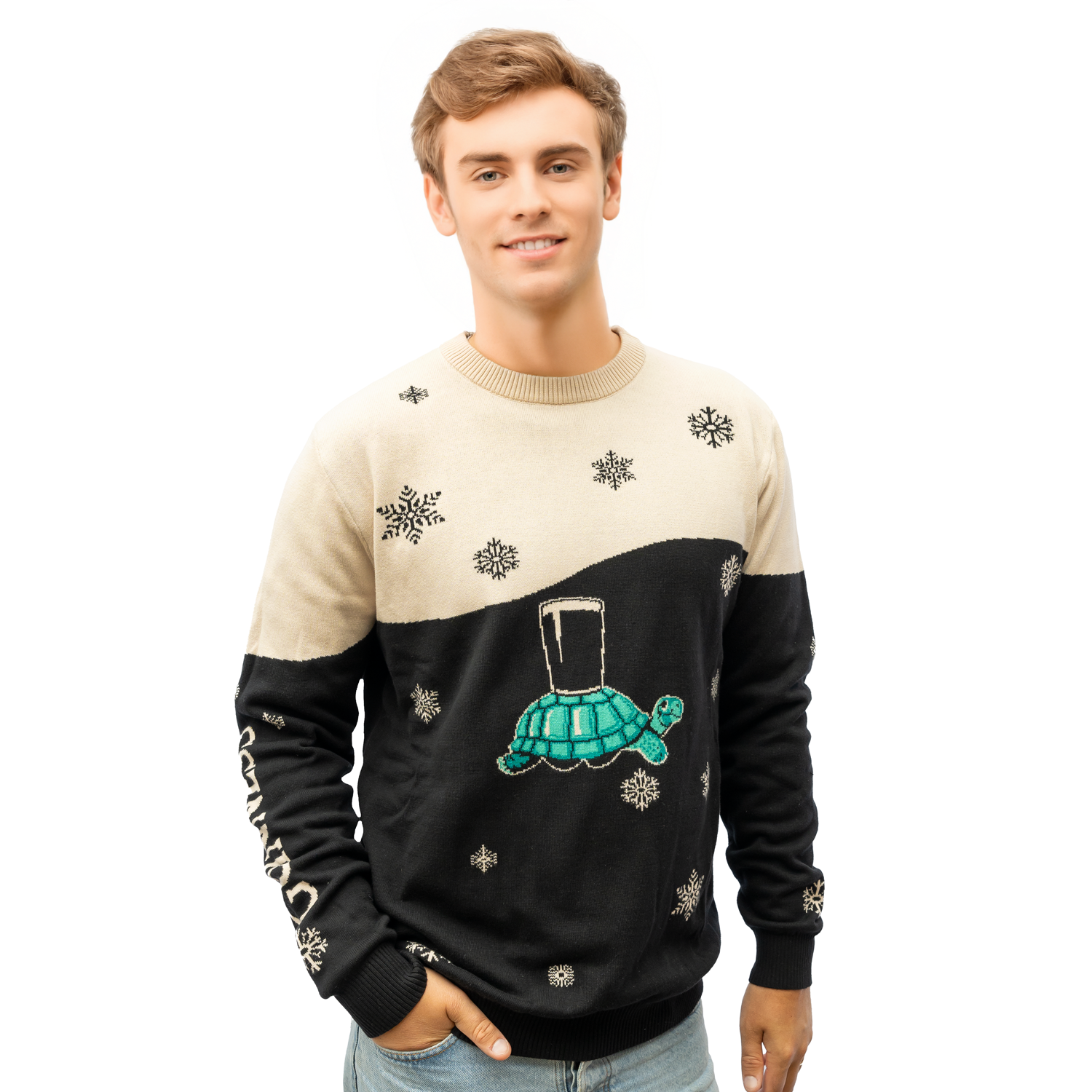 A young man wears the Guinness Holiday Black and Cream Tortoise Sweater from the Guinness Webstore US, featuring snowflake patterns and a turtle carrying a pint glass, against a white background.