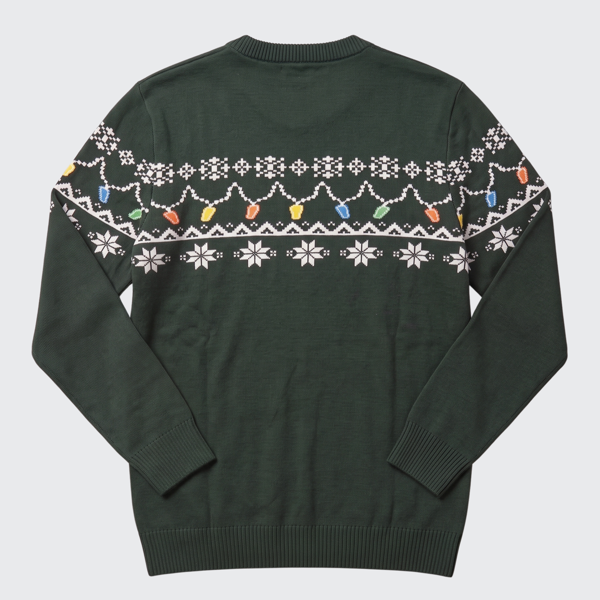 The Guinness Holiday Pint Lights Sweater - Green from Guinness Webstore US is shown flat with the back facing up, featuring a dark green color and a festive design of white snowflakes and colorful holiday lights across the upper chest and sleeves.