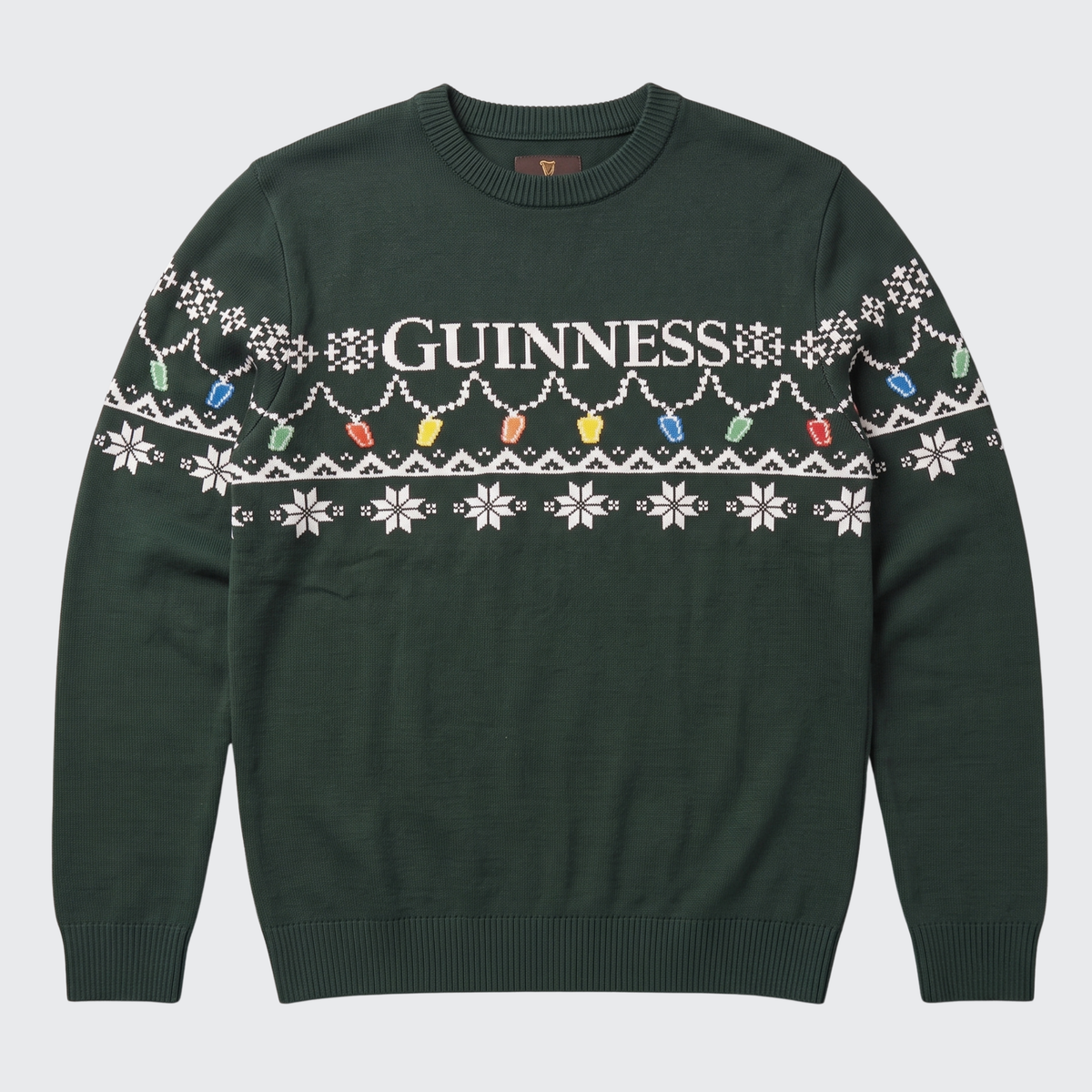 Ring in the holidays with the Guinness Holiday Pint Lights Sweater – Green from Guinness Webstore US, crafted from rich dark green fabric and adorned with classic “Guinness” lettering, crisp white snowflakes, and a cheerful row of colorful pint glass holiday lights along the chest and sleeves. The perfect choice for any festive gathering!.