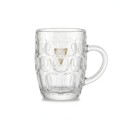 The Guinness Gold Harp Dimple Glass Mug – 20 oz Tankard from Guinness Webstore US features a classic dimpled design, sturdy handle, and clear glass with the classic gold harp logo, evoking the charm of an Irish pub mug on a white background.