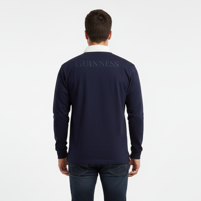 A man faces away in a Guinness Webstore US Navy Long Sleeve Rugby Shirt—100% cotton with "Guinness" across the back—showcasing classic Irish style against a plain white background.