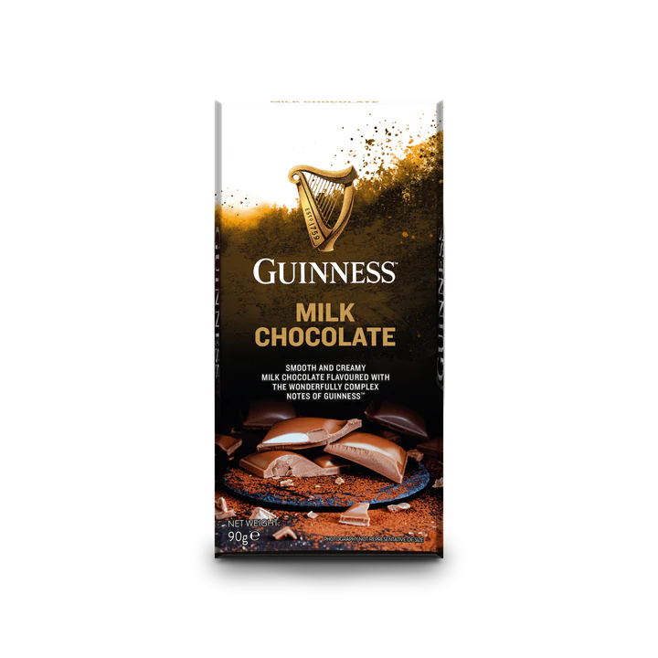 The Guinness Luxury Milk Chocolate Bar, crafted by Guinness, showcases smooth milk chocolate with chocolate pieces and a splash of liquid on the packaging.