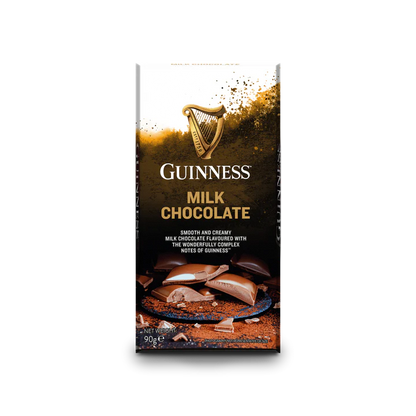 The Guinness Luxury Milk Chocolate Bar, crafted by Guinness, showcases smooth milk chocolate with chocolate pieces and a splash of liquid on the packaging.