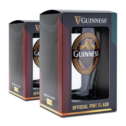 Two Guinness Classic Pint Glass Twin Pack glasses, each in a branded box, feature a gold and black design with the iconic logo and "Made of More" text.