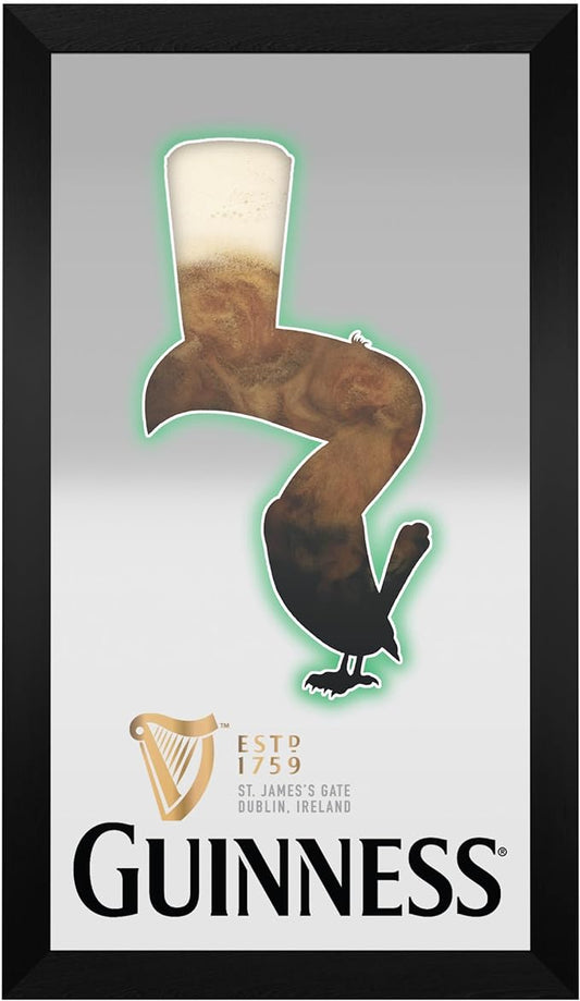 A framed advertisement, now an artistic mirror featuring the iconic Guinness logo with a distinctive toucan bird holding a pint of Guinness on its beak, along with the brand's harp emblem and text.