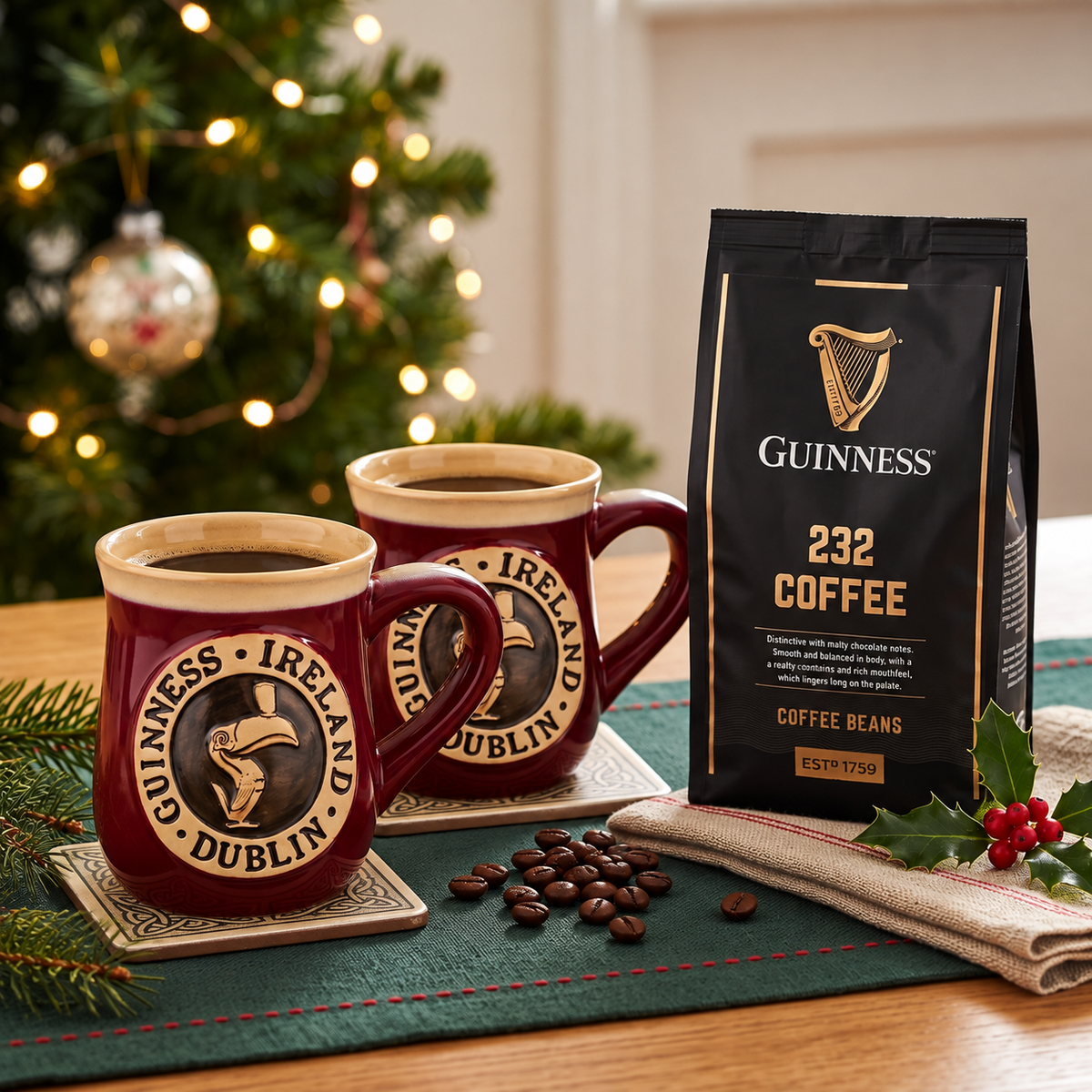 Two mugs of coffee sit beside a Guinness Morning Gift Set from Guinness Webstore US, with a Christmas tree and festive decorations in the background.