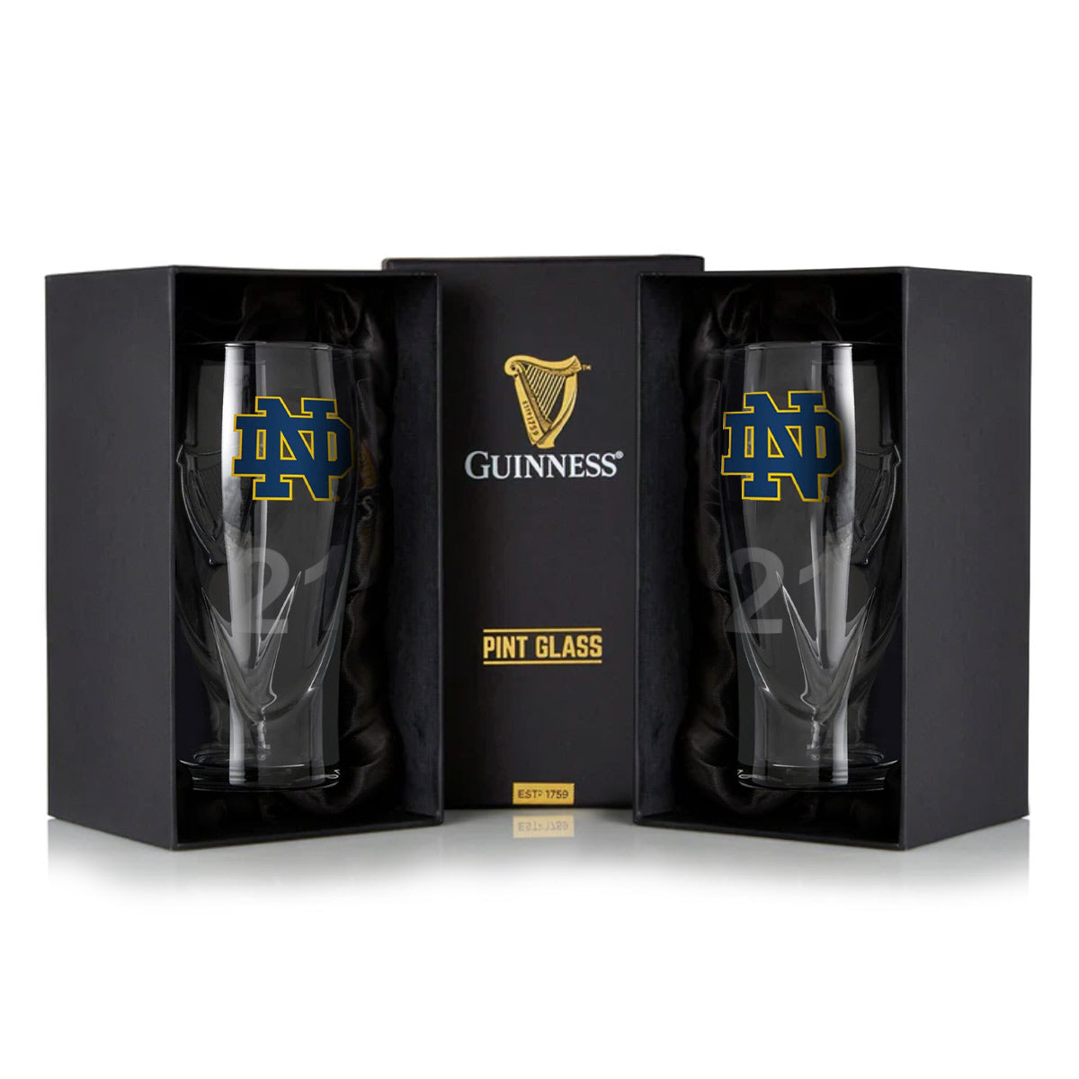 The Guinness Notre Dame 16OZ Pint Glass Twin Pack features two glasses in sleek black packaging, each with the classic Notre Dame logo, embodying the rich heritage of Guinness.