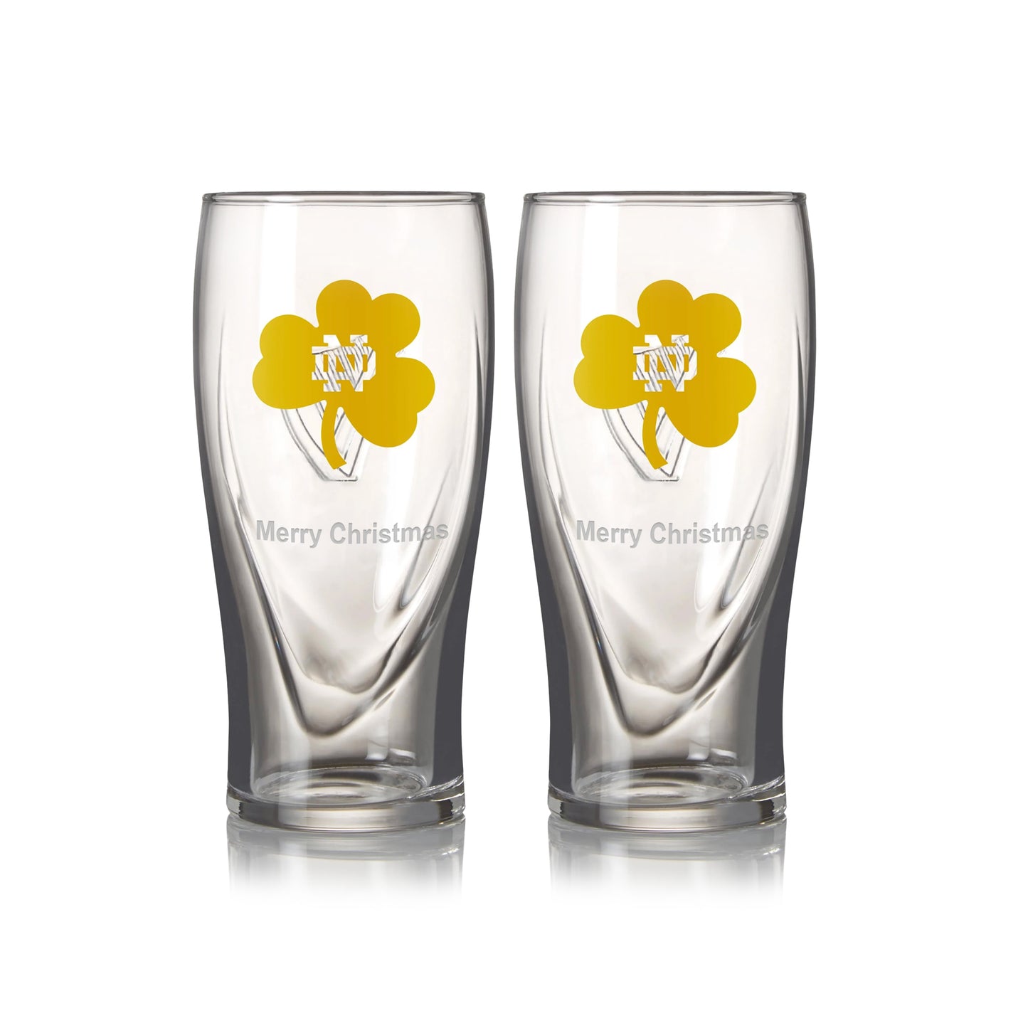 Two 16oz pint glasses featuring a yellow shamrock design with "Merry Christmas," from the Guinness Notre Dame Guinness Shamrock Twin Pack.