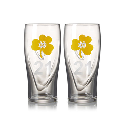 A twin pack of Guinness Notre Dame pint glasses, each 16oz, featuring transparent glass with yellow shamrock designs and the number "21".