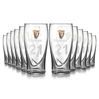 A 12-pack of Guinness pint glasses, elegantly featuring the iconic logo and number 21, arranged in two lines. The embossed harp adds sophistication to these timeless pieces.