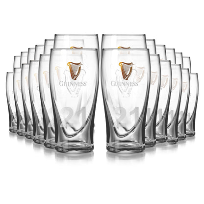 Guinness Pint Glasses from the 24-pack, each showcasing the iconic logo and an embossed harp, are neatly arranged.