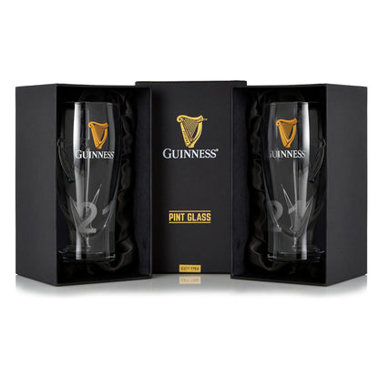 The Guinness Pint Glass Twin Pack features two glasses in a black gift box with gold accents. Each glass showcases the iconic Guinness logo and harp symbol, making it ideal for enhancing your beer glass collection and ensuring a perfect pint every time.