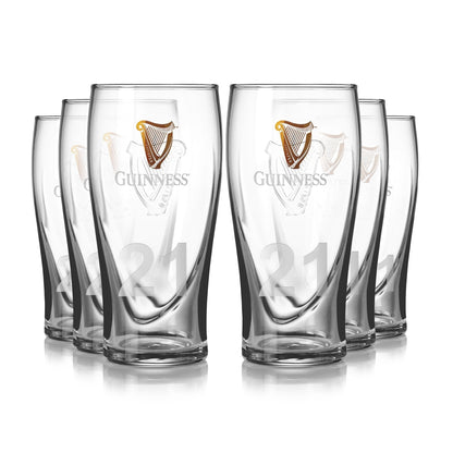 A pack of six clear Guinness pint glasses, etched with the iconic logo and the number 21, arranged in two rows.