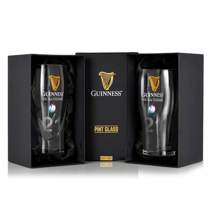 The Guinness Six Nations Pint Glass - 2 Pack from Guinness Webstore US features two rugby-logo pint glasses displayed upright in black presentation boxes with a central GUINNESS pint glass label between them.