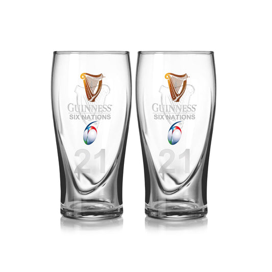 The Guinness Six Nations Pint Glass - 2 Pack from Guinness Webstore US includes two clear glasses with the 2021 Six Nations logo and a colorful rugby ball graphic—ideal for enjoying drinks while watching rugby.