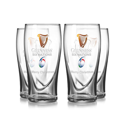 The Guinness Six Nations Pint Glass - 4 Pack from Guinness Webstore US features four clear glasses with the Six Nations logo and "Merry Christmas" text—ideal for rugby fans' matchday celebrations.