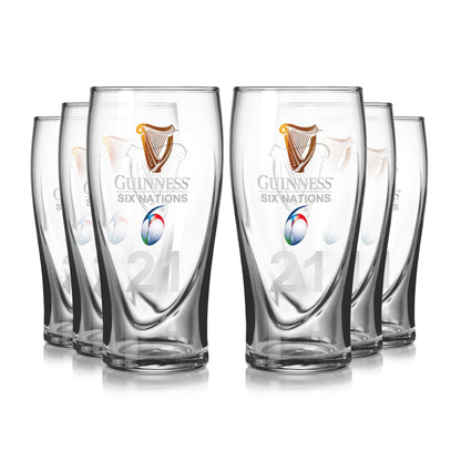 The Guinness Six Nations Pint Glass - 6 Pack from Guinness Webstore US features six clear pint glasses with rugby and Six Nations logos, number 21, ideal for rugby fans. Glasses are arranged in two rows on a white background.