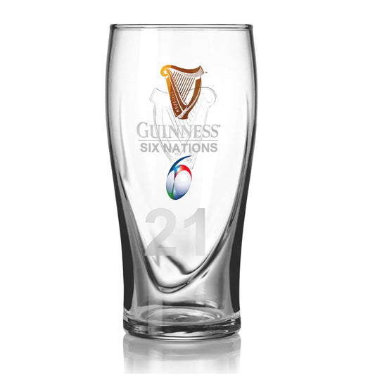 The Guinness Six Nations Pint Glass from Guinness Webstore US features the classic Guinness Harp Logo, the tournament emblem, and a gold harp with the number 21 etched near the base—perfect for rugby fans.