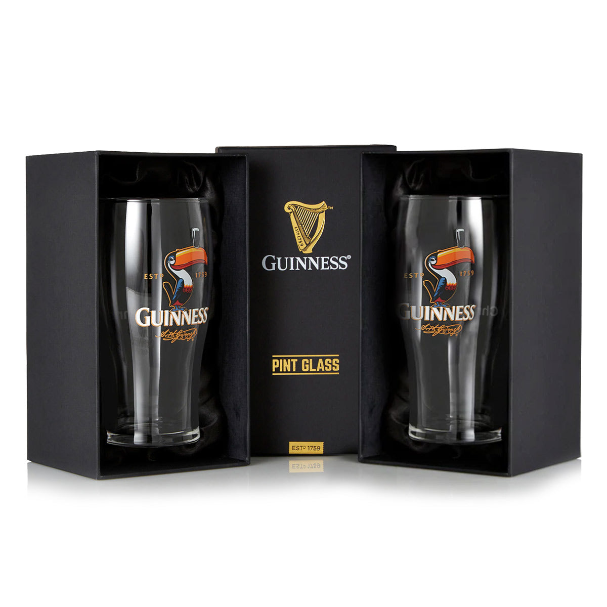 The Guinness Toucan Pint Glass Twin Pack contains two glasses in black packaging, featuring the iconic Toucan design with the brand's signature harp, capturing the essence of classic Guinness advertising.