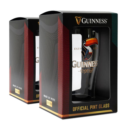 The Guinness Toucan Pint Glass Twin Pack, featuring the iconic toucan graphic, is set against a plain backdrop.