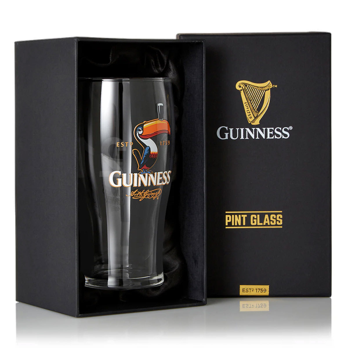 The Guinness Toucan Pint Glass features a retro design with the classic toucan logo, packaged in a sleek black box adorned with golden "Guinness" and "Pint Glass" text.