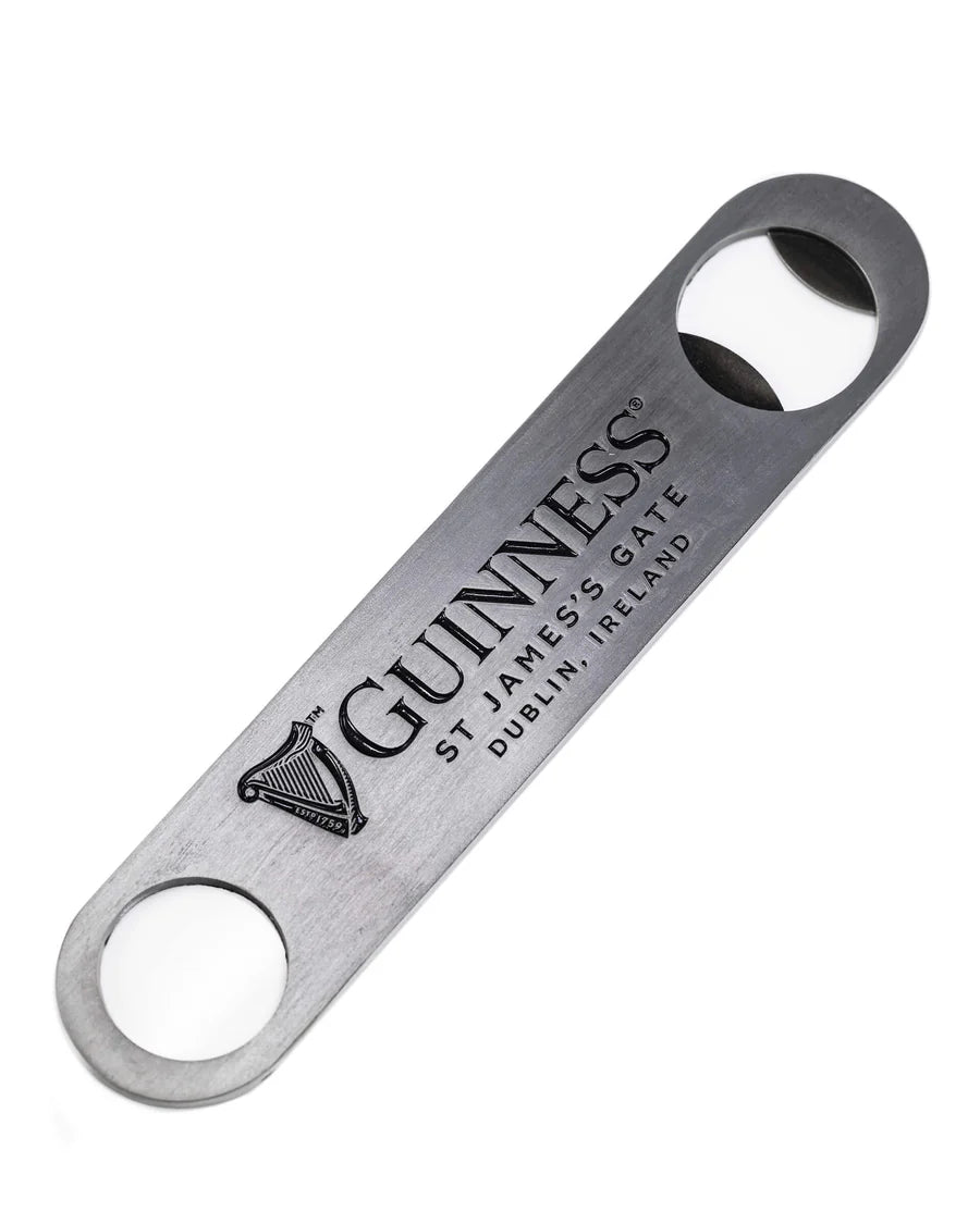 The Guinness Barman Bottle Opener from Guinness Webstore US is a flat metal opener with two circular ends, featuring the Guinness logo and "St. James’s Gate, Dublin, Ireland"—a classic addition to any home bar.