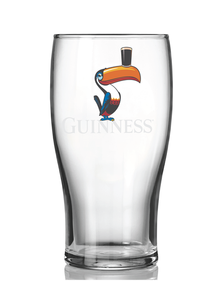 The Guinness Toucan Pint Glass Twin Pack features 20 oz clear glasses with colorful toucan illustrations balancing a pint on their beaks, echoing classic Guinness ads with the iconic Guinness logo.