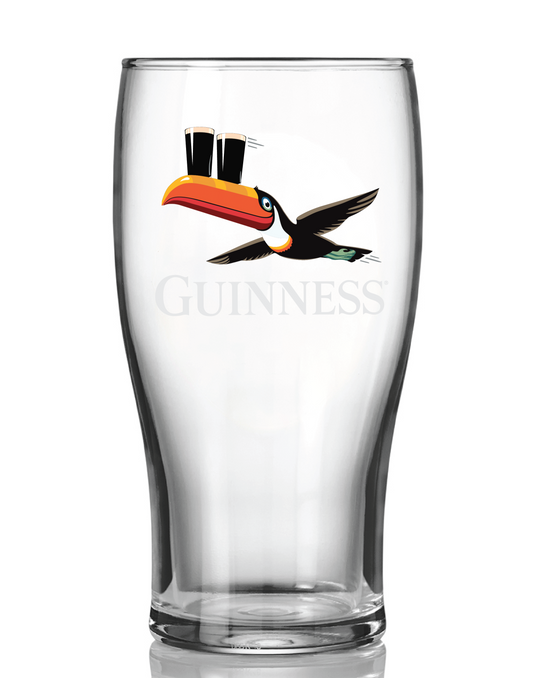 The Guinness Gilroy Flying Toucan Pint Glass from Guinness Webstore US features a clear tulip shape and John Gilroy’s iconic flying toucan balancing two pints of stout on its beak, with the classic Guinness logo.