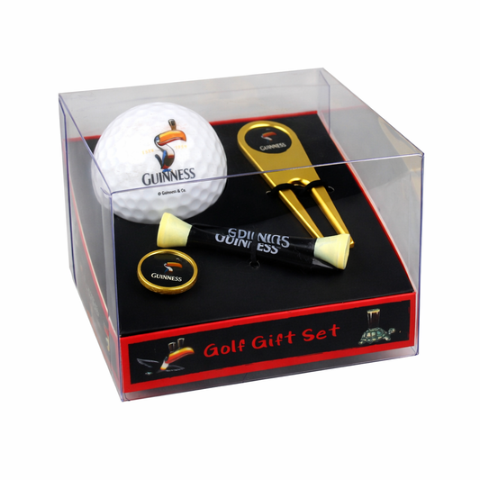 Introducing the Guinness Gilroy Golf Gift Set: a clear box containing a Guinness Webstore US-branded golf gift set, featuring John Gilroy artwork. Inside, you'll find a golf ball, tees, ball marker, and divot repair tool—a true collector's item for any golf enthusiast.
