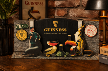 A Guinness display features cutouts of animals, a zookeeper, and vintage Guinness branding from the John Gilroy zoo campaign, set against a brick wall adorned with beer glasses, Irish-themed decor, and the Guinness Gilroy Wooden Sign - 3D St James Gate from the Guinness Webstore US.