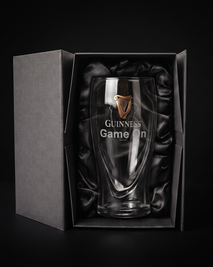 The Personalized Guinness Glass Gift Set from Guinness Webstore US sits upright in a black, satin-lined box—an ideal gift against a dark background.