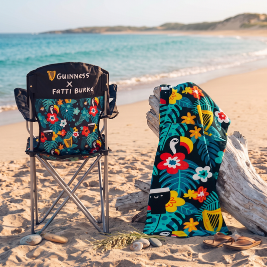 Guinness x Fatti Burke Hawaiian camping chair and beach towel bundle on the beach.