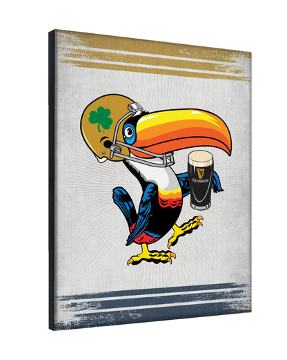 Showcasing a toucan in a football helmet with a shamrock and pint of Guinness, this officially licensed Guinness Notre Dame Toucan Canvas Wall Art is perfect for fans and collectors.